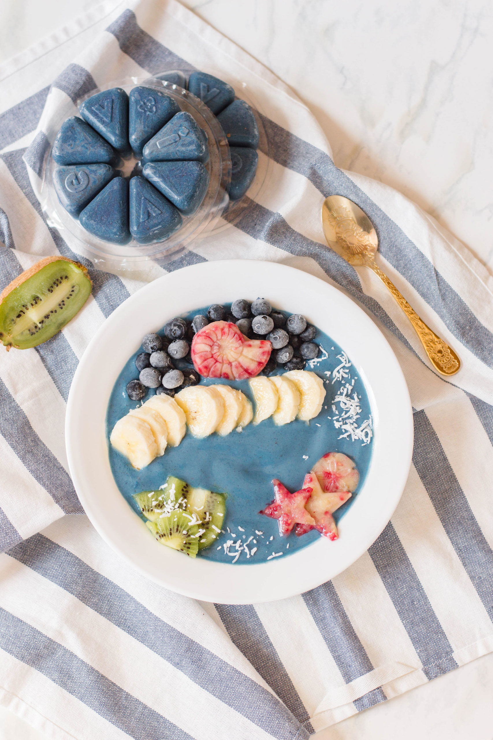 This Mermaid Smoothie Bowl has all the mermaid magic you need - and the deliciousness! Using an Evive Smoothie blend, this smoothie bowl came to life with the help of delicious, vibrant fruit like blueberries and kiwi. #smoothiebowl #breakfastgoals