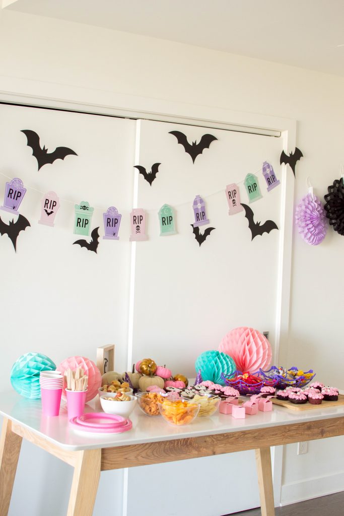Come celebrate with us as we put together the cutest Pink Halloween Party! We have all the party details – from homemade donuts to pastel décor that made our Pink Halloween Bash a success!